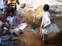 Studying an outcrop along the Lukenie River, Congo basin